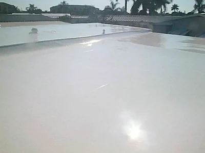 Seamless white silicone coating applied over commercial single ply roof in Fort Myers FL