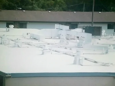 Seamless commercial roofing in Fort Myers FL featuring a reflective urethane silicone coating system